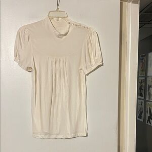 Deletta Anthropologie cream mock turtleneck top. Button shoulder & sleeve detail